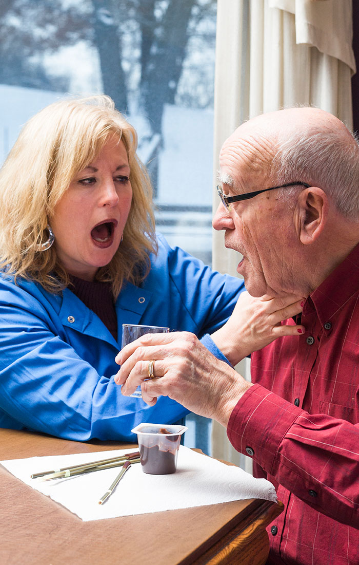 Speech therapist listens for dry voicing after swallowing.