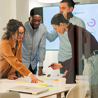 a group of people looking at a report